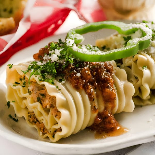 Monjunis Italian Cafe & Grocery's lasagna roll-ups with meat sauce, parsley, parmesan, and a green pepper ring.
