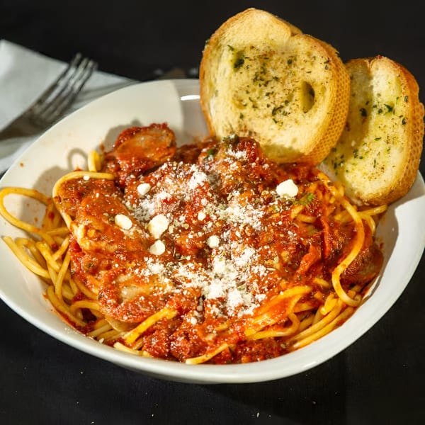 Monjunis Italian Cafe & Grocery's spaghetti with meatballs, red sauce, parmesan, and garlic bread.
